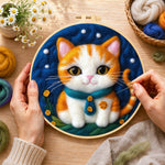 Creating the cosy orange cat with teal bow tie wool painting by hand with a felting needle