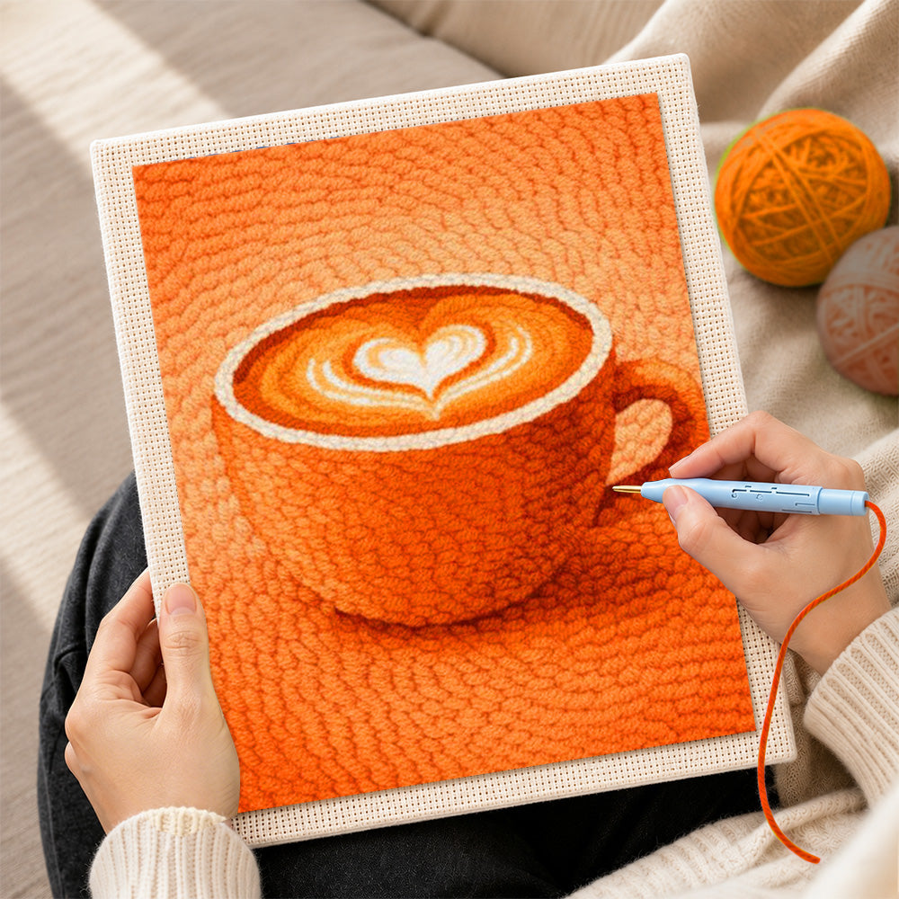 Creating handmade cosy orange coffee cup with heart latte art punch needle artwork
