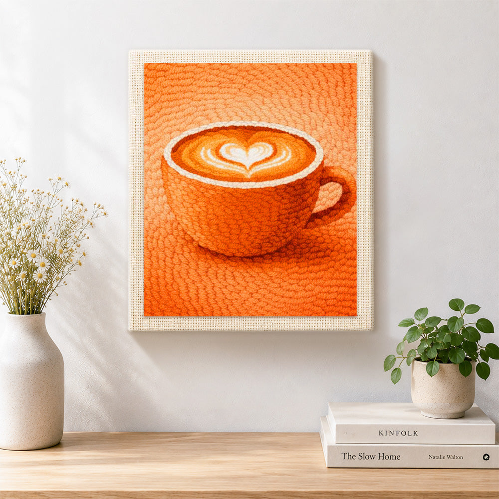 Finished cosy orange coffee cup with heart latte art artwork displayed on a wall