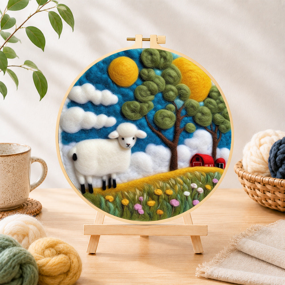 Finished cosy red barn farm scene with sheep needle felting displayed on a wooden easel