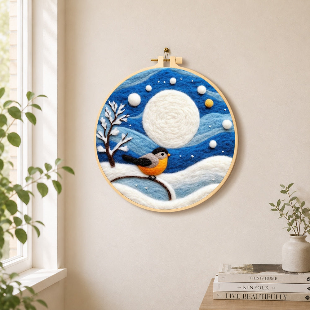 Cosy winter bird under the full moon needle felt wall art displayed in a bright home interior
