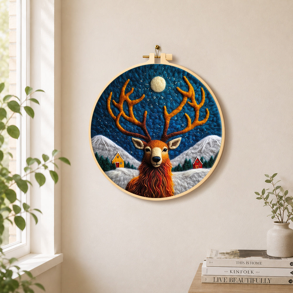 Cosy winter cabin and stag needle felt wall art displayed in a bright home interior