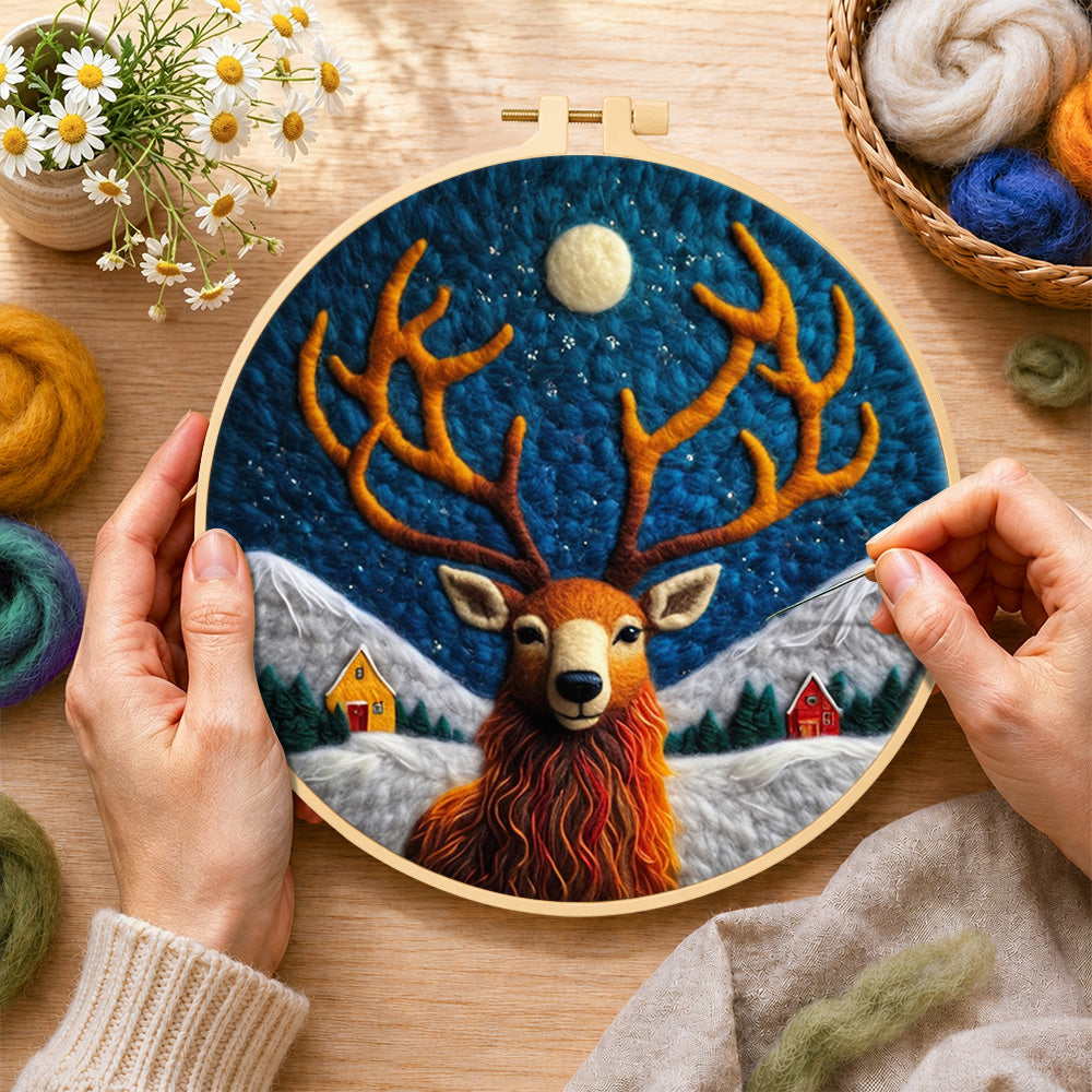 Creating the cosy winter cabin and stag wool painting by hand with a felting needle