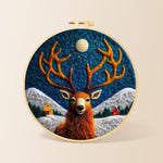 Cosy winter cabin and stag needle felting kit for beginners with a round wooden frame