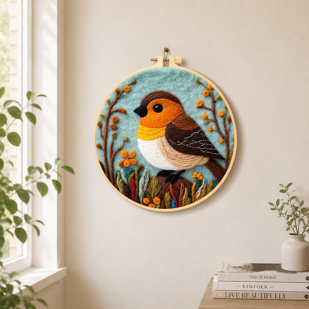 Cosy woodland bird needle felt wall art displayed in a bright home interior