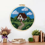 Finished countryside cottage with pathway artwork displayed on a wall