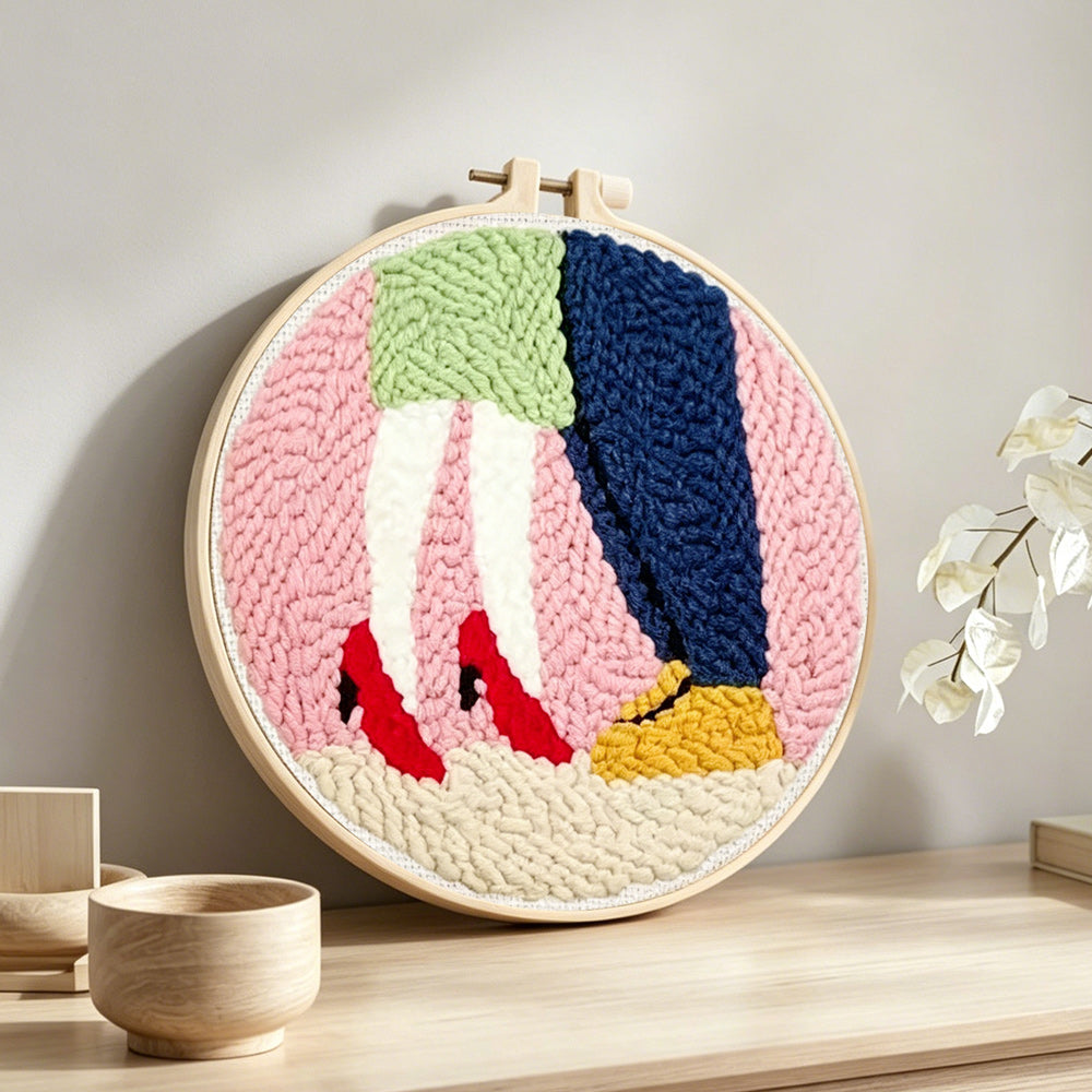 Couple embracing punch needle artwork displayed on a table