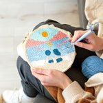 Creating handmade couple on beach at sunset punch needle artwork