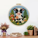 Finished cow in the meadow and flower forest artwork displayed on a wall