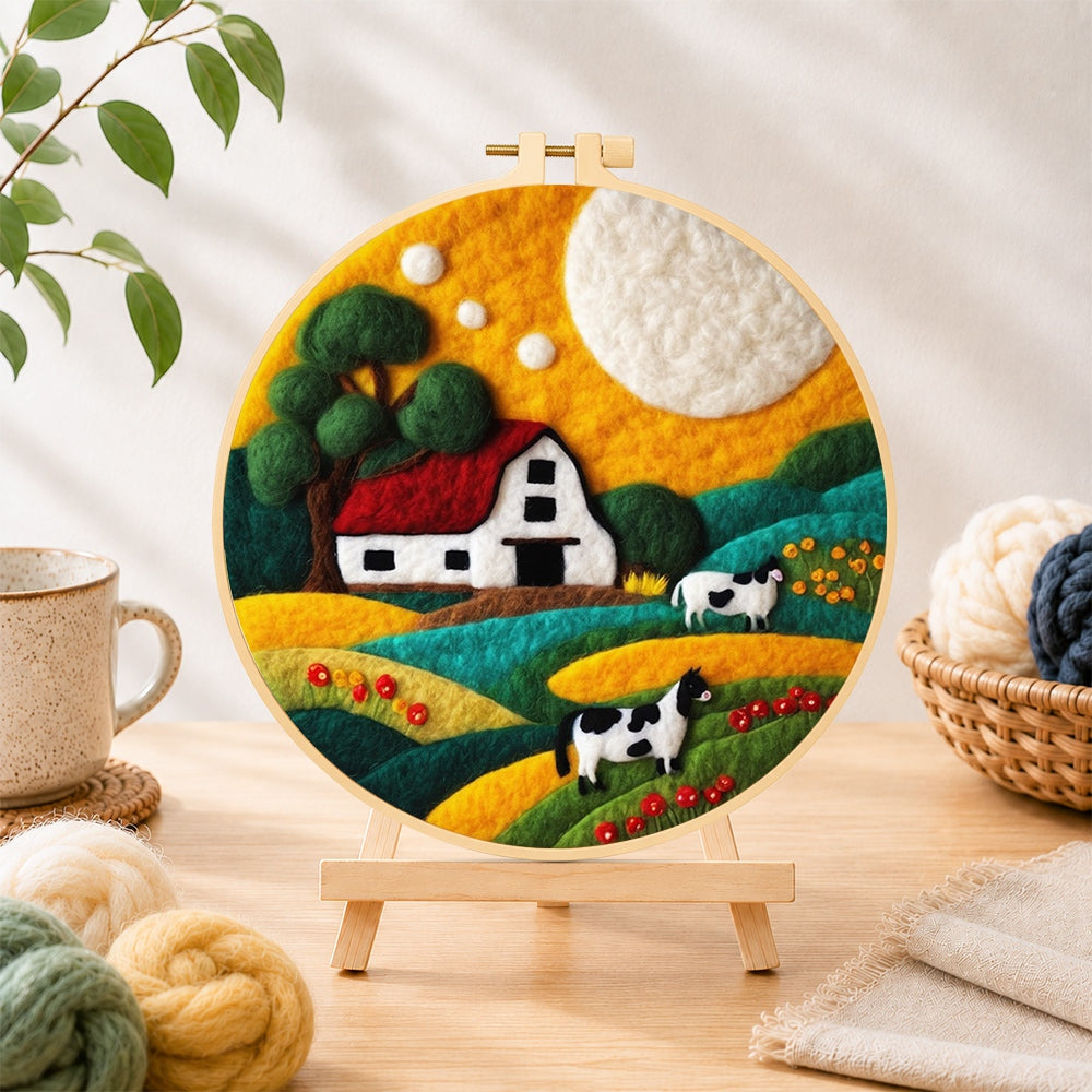 Finished cows and farm life needle felting displayed on a wooden easel