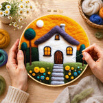 Creating the cozy cottage and orange sunset wool painting by hand with a felting needle