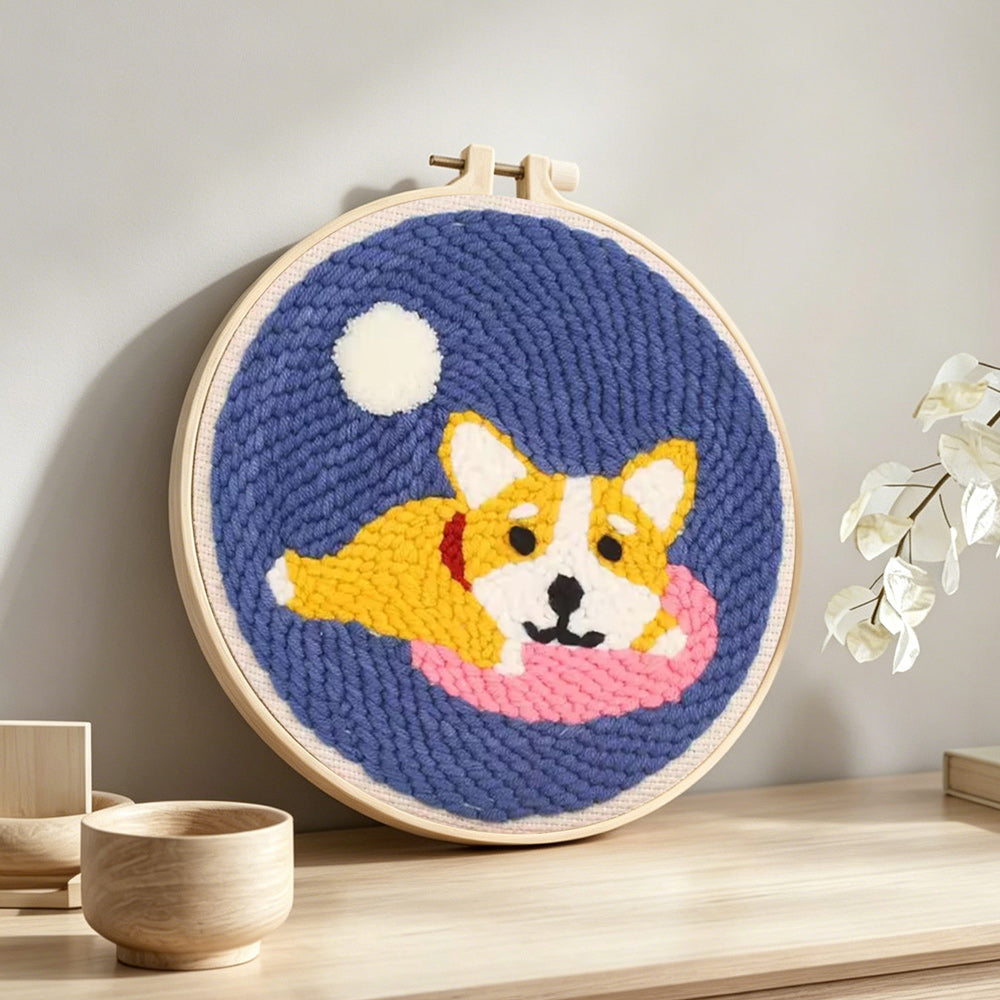 Cozy dog punch needle artwork displayed on a table