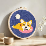 Cozy dog punch needle artwork displayed on a table
