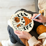 Creating handmade cozy ghost with pumpkin spice latte punch needle artwork