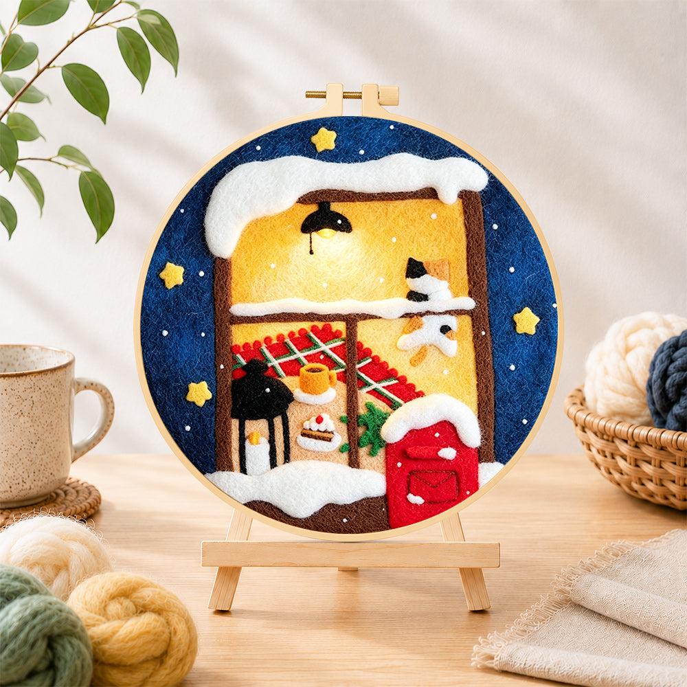 Finished cozy winter window needle felting displayed on a wooden easel