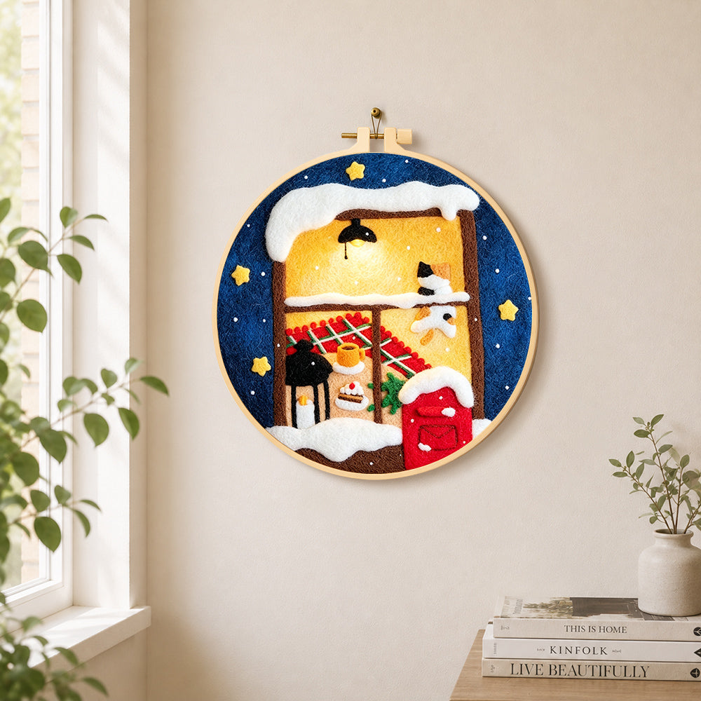 Cozy winter window needle felt wall art displayed in a bright home interior