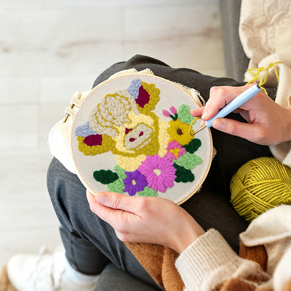 Creating handmade cream floral highland cow punch needle artwork