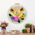 Finished cream floral highland cow artwork displayed on a wall