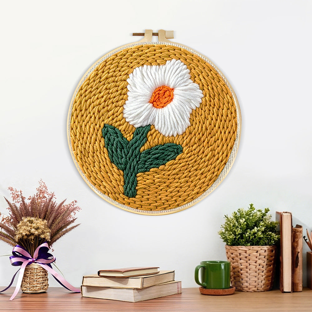 Finished cream flower on mustard yellow artwork displayed on a wall