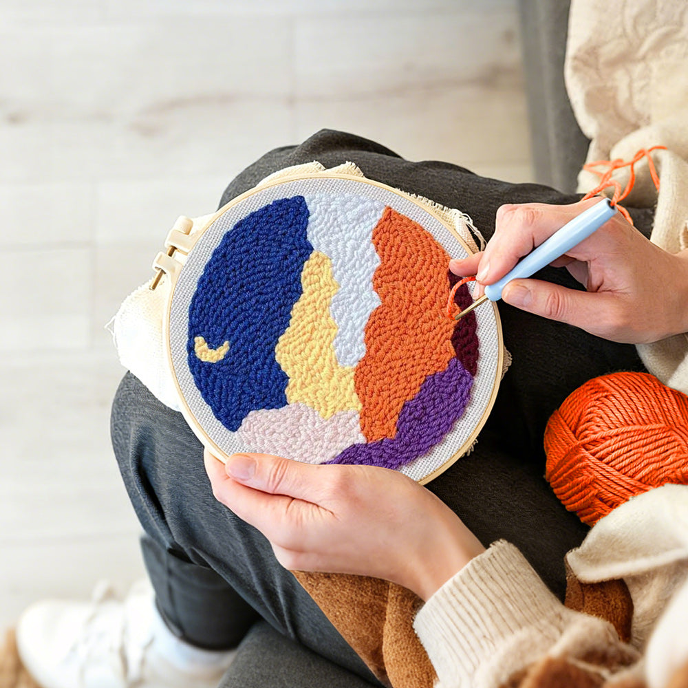 Creating handmade crescent moon and colourful layered clouds punch needle artwork