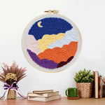 Finished crescent moon and colourful layered clouds artwork displayed on a wall