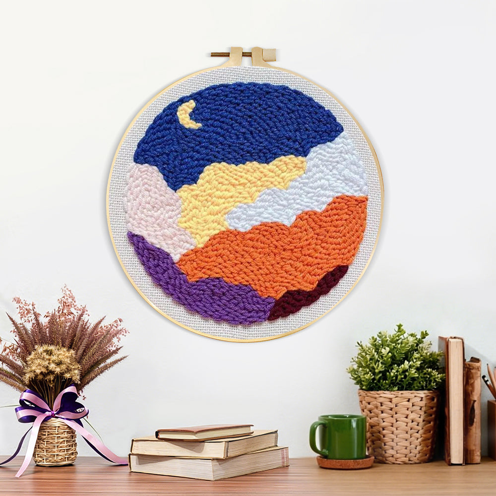 Finished crescent moon and colourful layered clouds artwork displayed on a wall