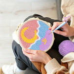 Creating handmade crescent moon over mountain and sea punch needle artwork