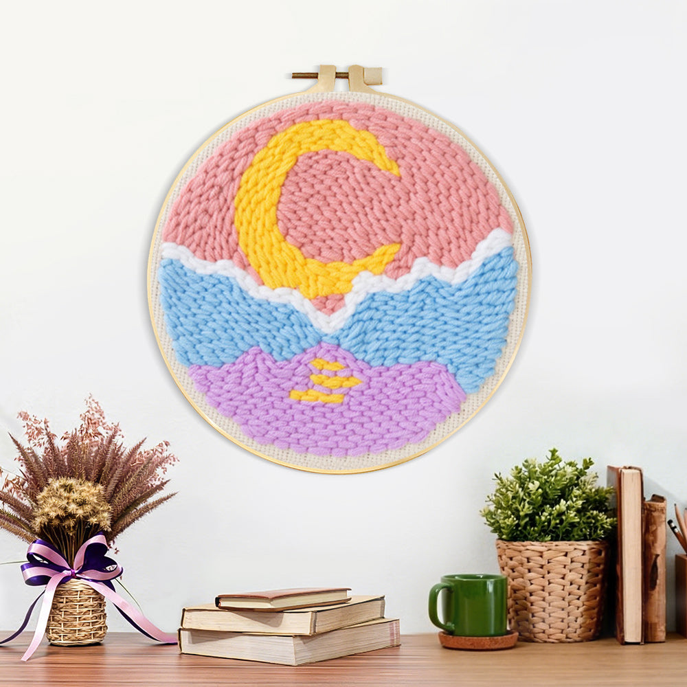 Finished crescent moon over mountain and sea artwork displayed on a wall