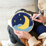 Creating handmade crescent moon over starry night sky punch needle artwork