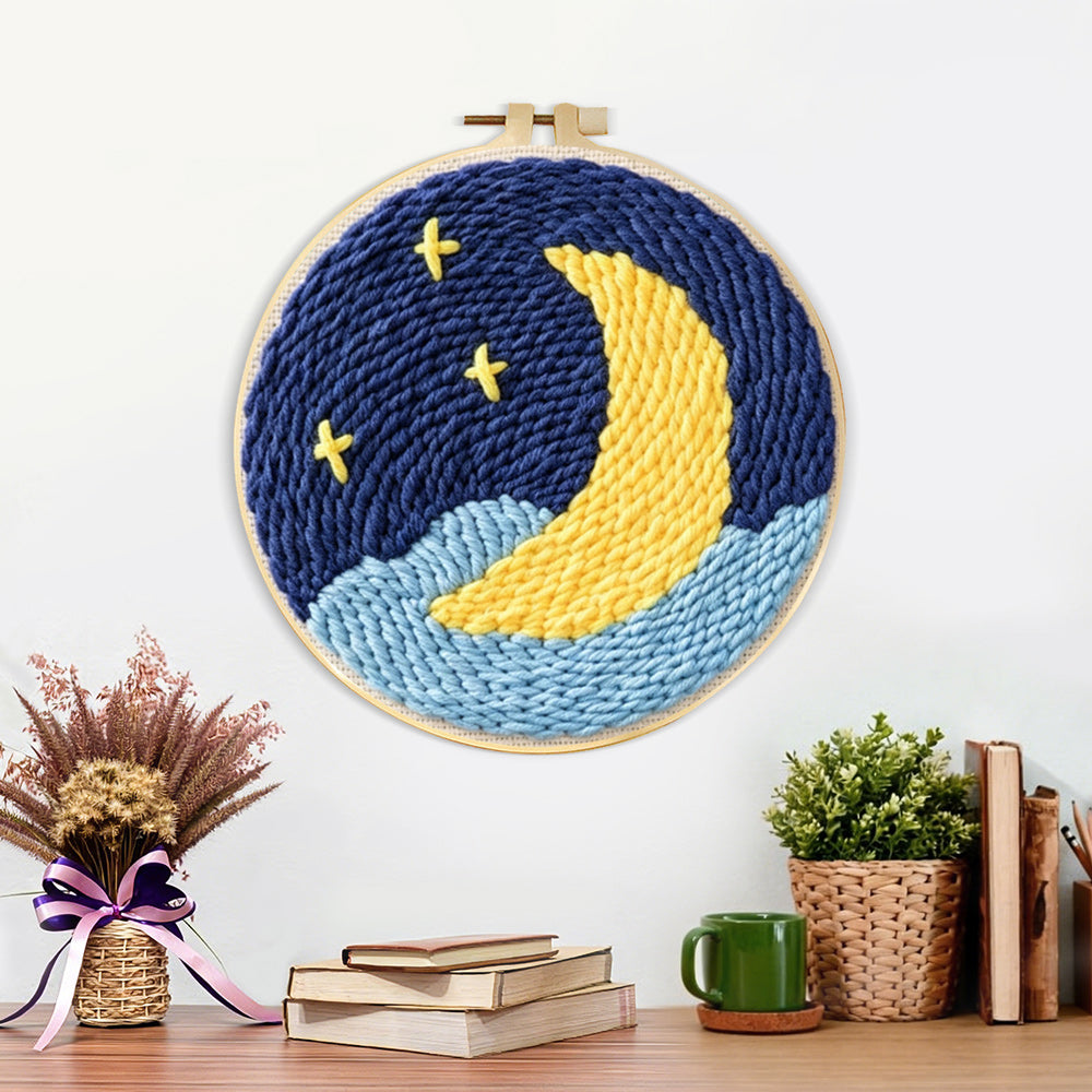 Finished crescent moon over starry night sky artwork displayed on a wall