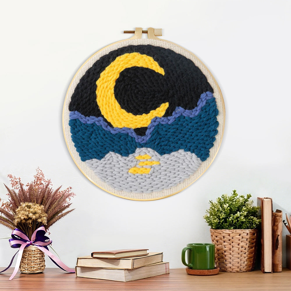 Finished crescent moon, sea and mountains artwork displayed on a wall