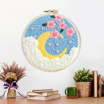 Finished crescent moon with pink flowers artwork displayed on a wall