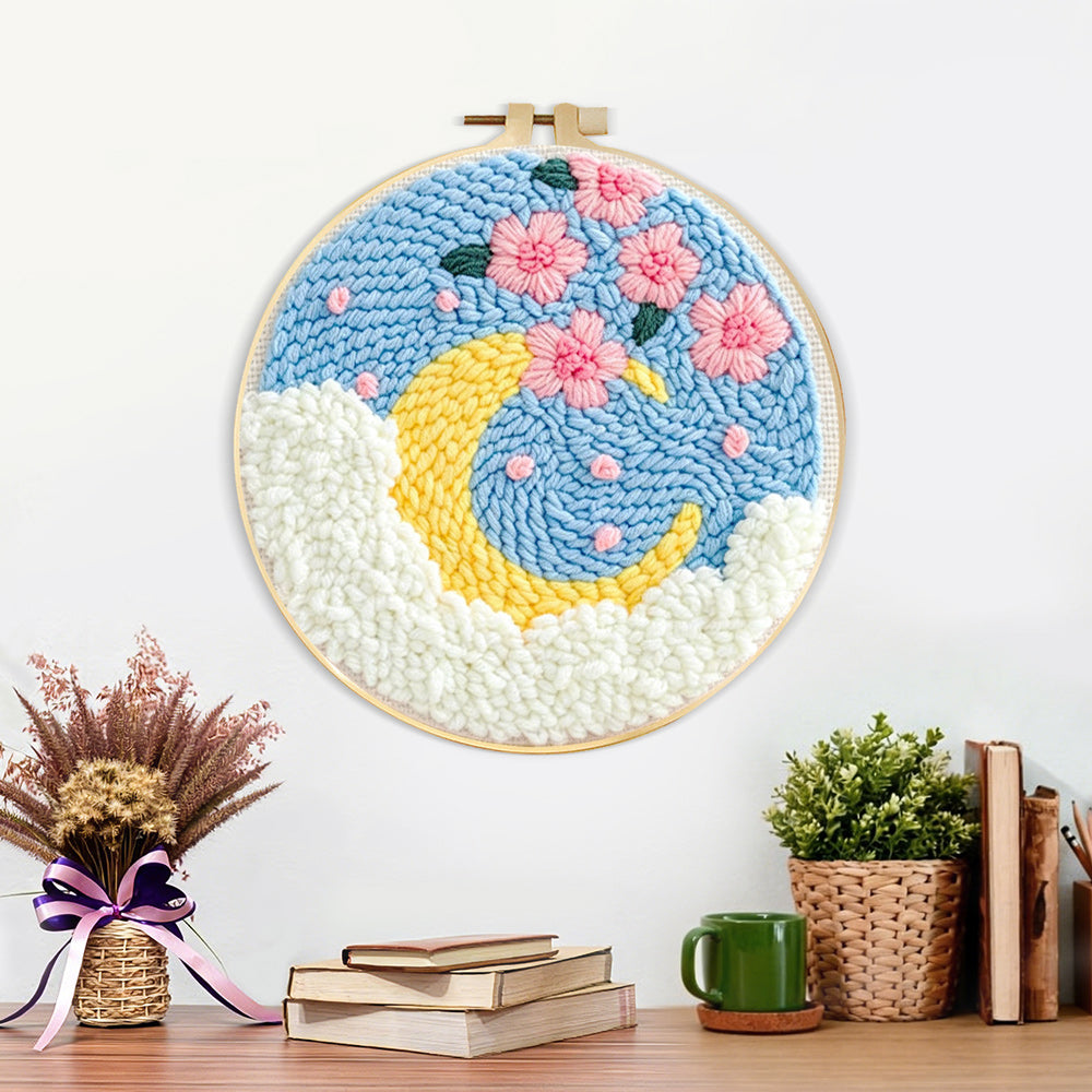 Finished crescent moon with pink flowers artwork displayed on a wall
