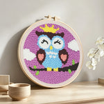 Crowned owl punch needle artwork displayed on a table