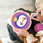 Creating handmade crowned princess penguin punch needle artwork