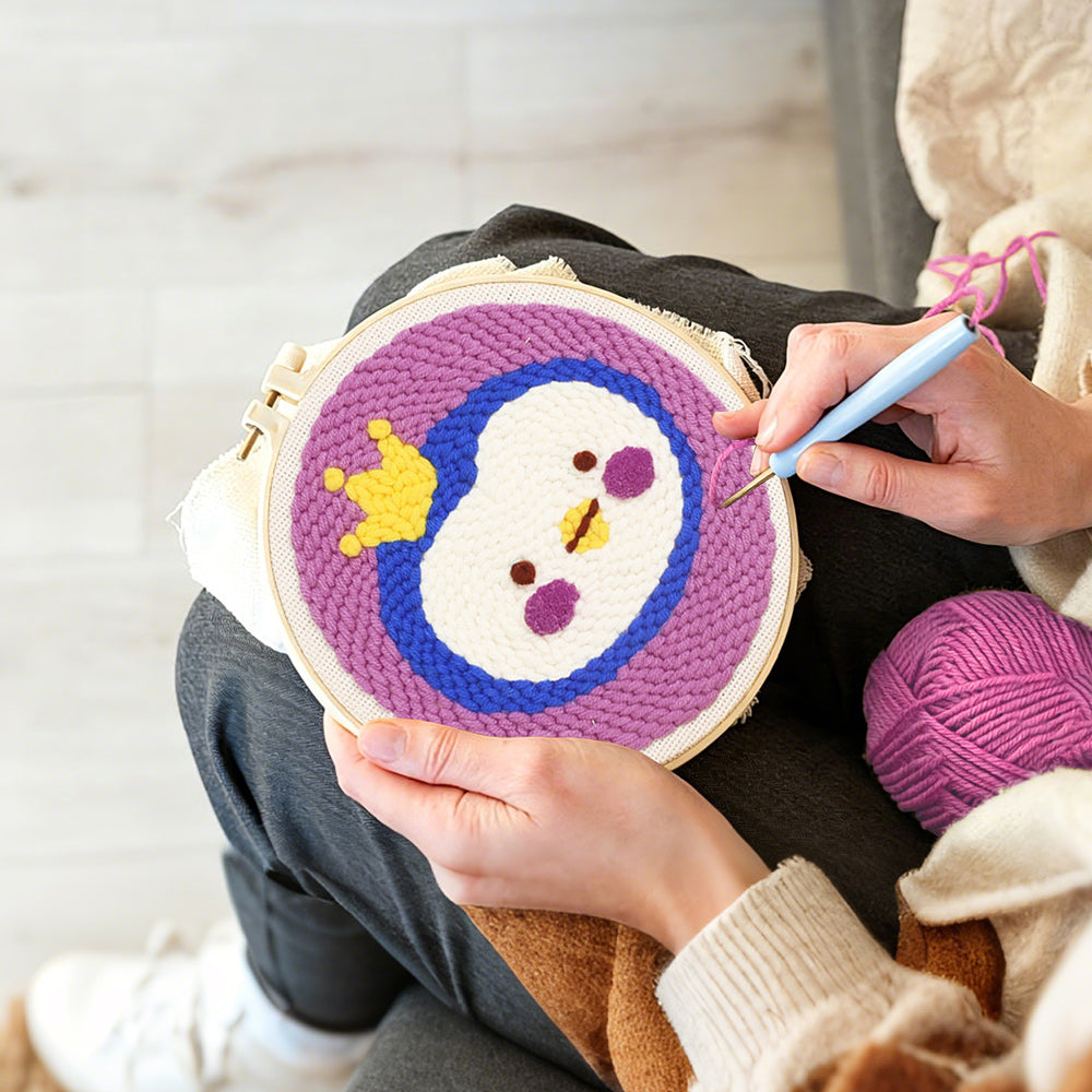 Creating handmade crowned princess penguin punch needle artwork