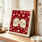 Cuddling puppy duo punch needle artwork displayed on a table