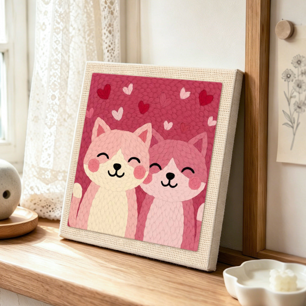 Cuddly pink cat duo punch needle artwork displayed on a table