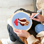 Creating handmade cupcake with red umbrella punch needle artwork
