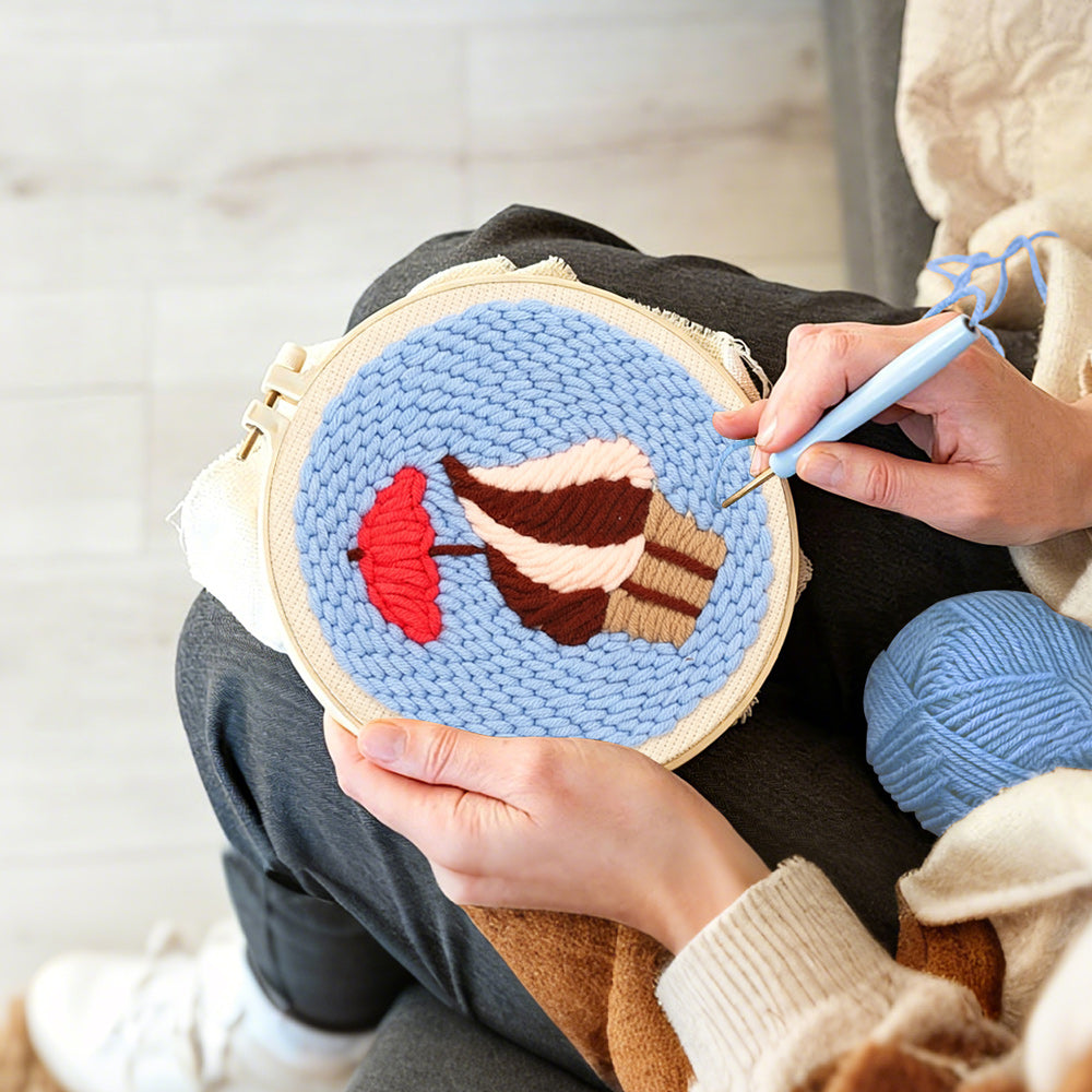 Creating handmade cupcake with red umbrella punch needle artwork