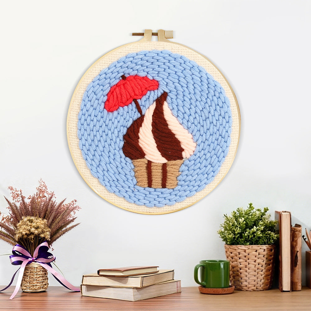 Finished cupcake with red umbrella artwork displayed on a wall