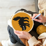 Creating handmade curled black cat punch needle artwork