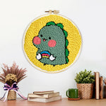 Finished cute baby dinosaur artwork displayed on a wall