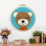 Finished cute bear with orange bow tie artwork displayed on a wall