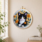 Cute black and white kitten needle felt wall art displayed in a bright home interior