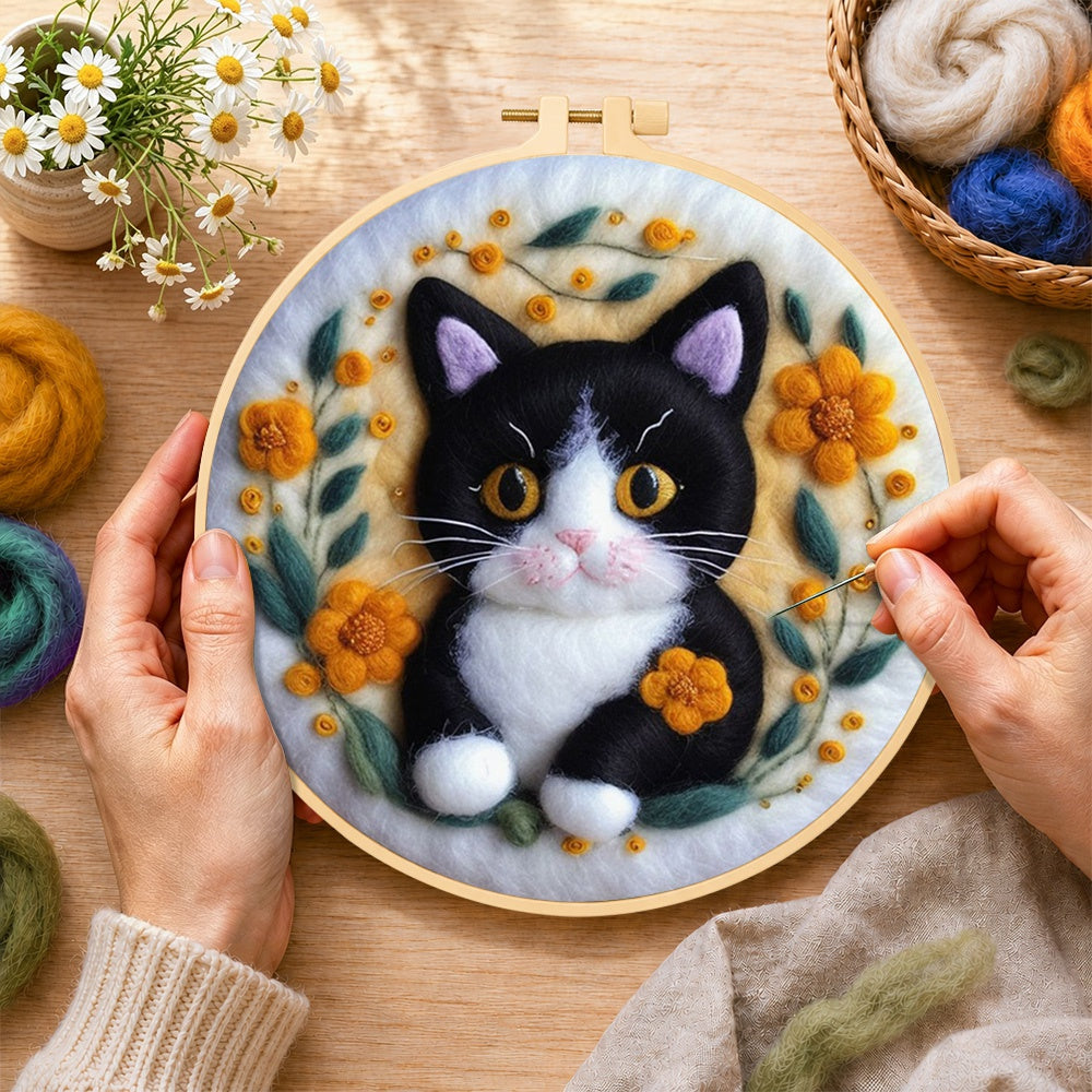 Creating the cute black and white kitten wool painting by hand with a felting needle