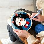 Creating handmade cute black haired girl punch needle artwork