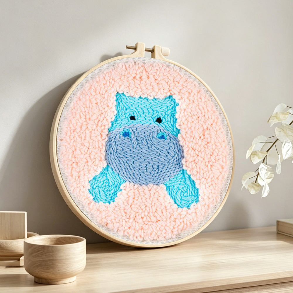 Cute blue hippo punch needle artwork displayed on a table
