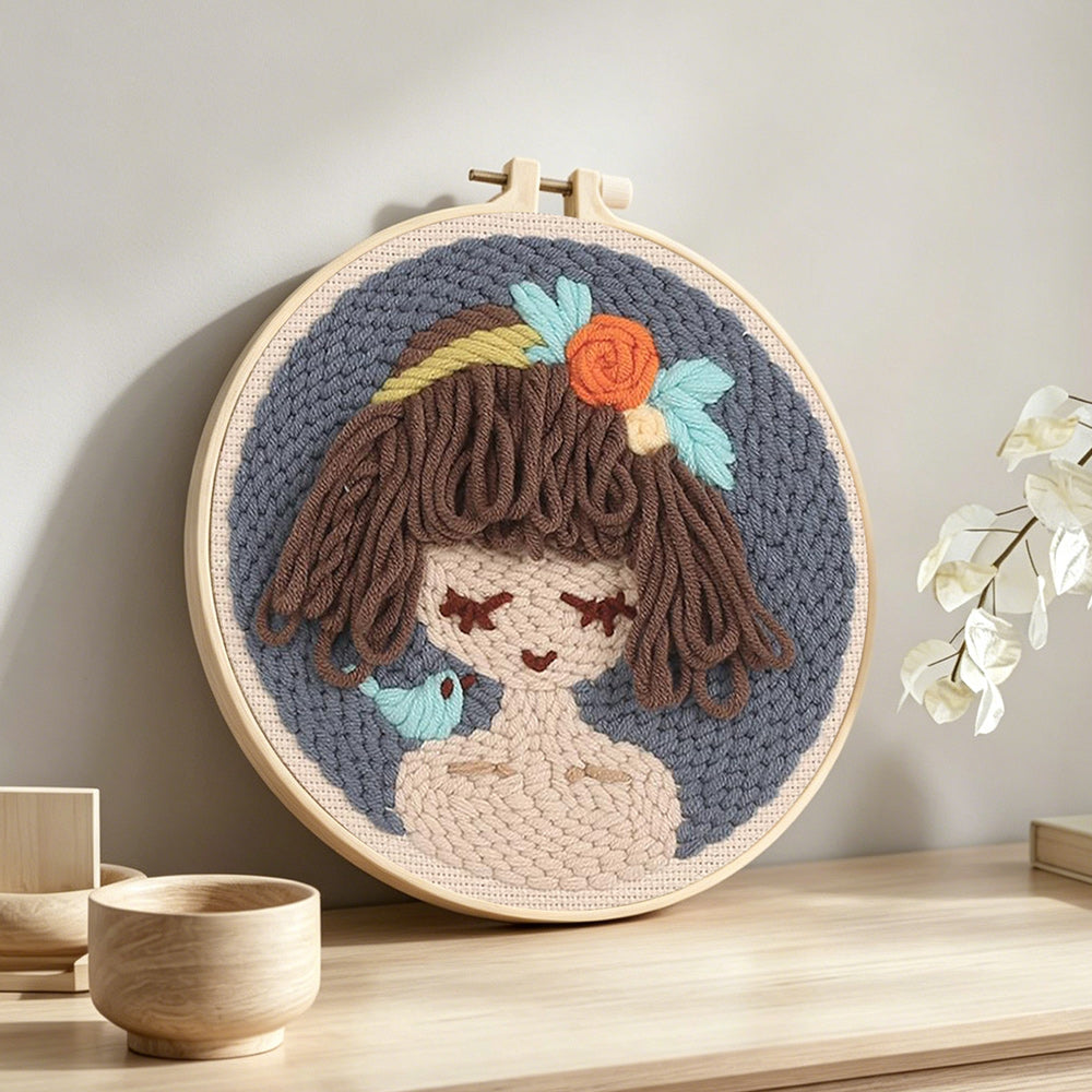 Cute brown haired girl punch needle artwork displayed on a table