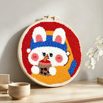 Cute bunny drinking boba punch needle artwork displayed on a table